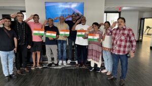 A group of Indian artists holding the Indian flag, symbolizing unity and diversity.
